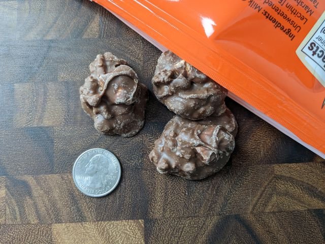 Trader Joe's S'mores Clusters top-down view with quarter for size comparison.