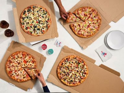 Various Domino's pizzas from a top-down view.