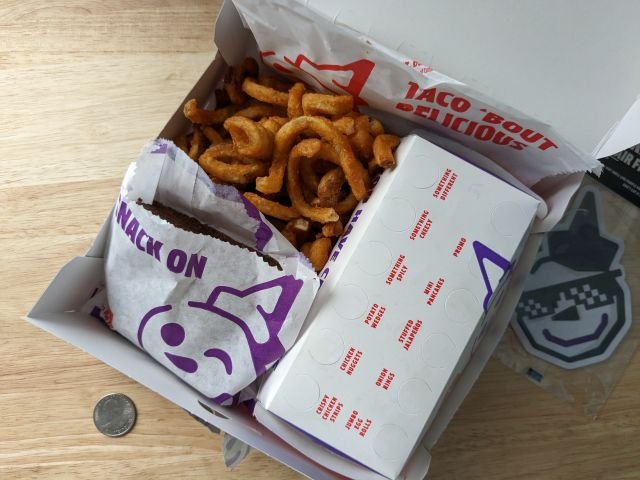 Jack in the Box Snoop's Munchie Meal inside box with coin for size comparison.