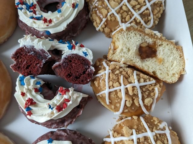 Krispy Kreme Red Velvet Sparkler Donut and All-American Pie Donut cross-section.