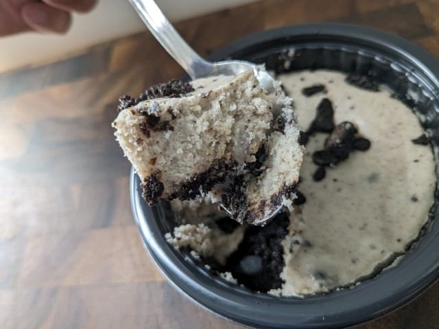 Popeyes Oreo Cheesecake Cup spoonful close-up.