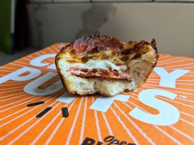 Cross-section of a Little Caesars Pepperoni Crazy Puffs with a middle hollow.